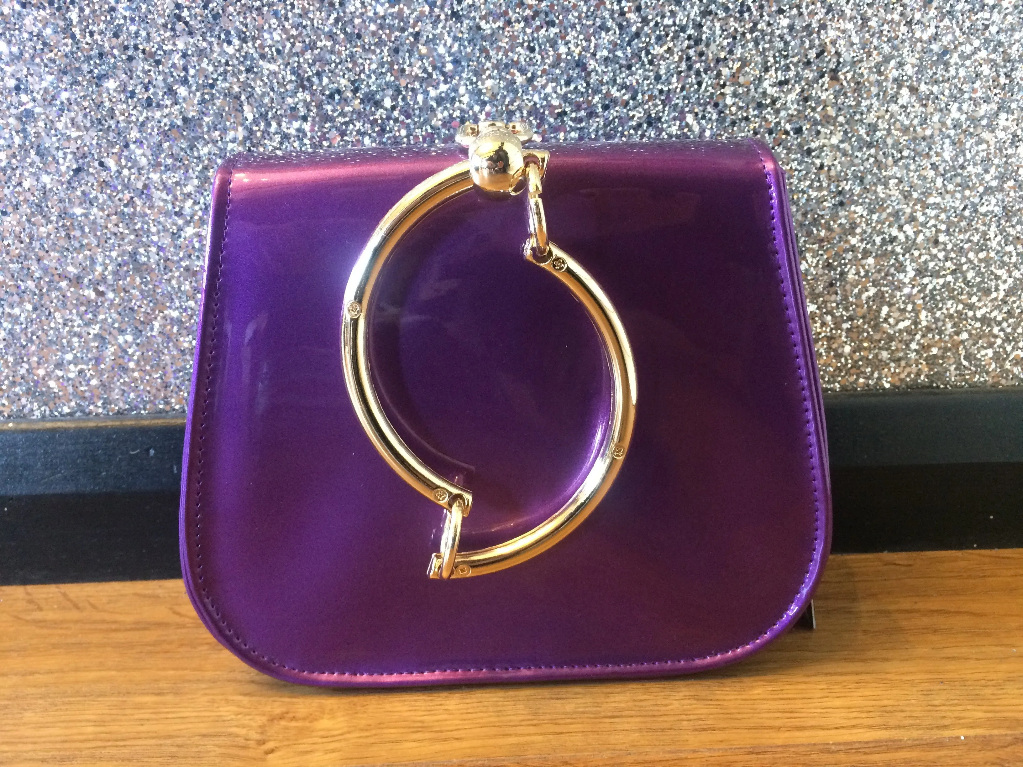 Gold Circle Handle Patent Handbag